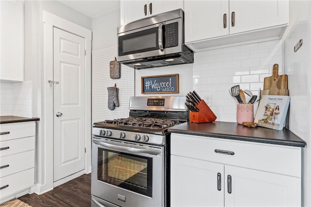 kitchen with white cabinetry, stainless steel appliances, dark hardwood / wood-style flooring, and backsplash