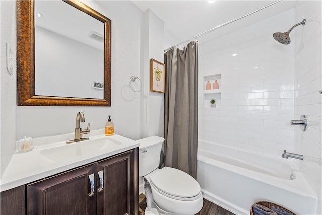 full bathroom featuring vanity, shower / tub combo with curtain, and toilet