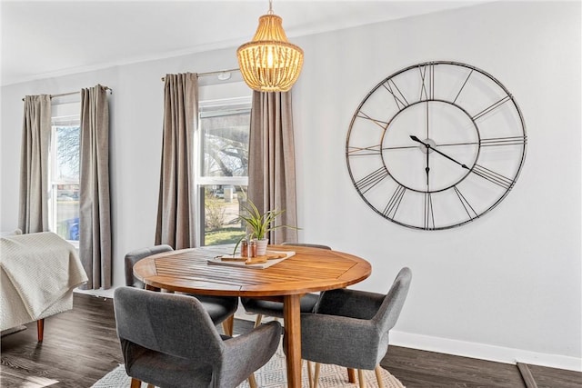 dining room with dark hardwood / wood-style flooring and a chandelier