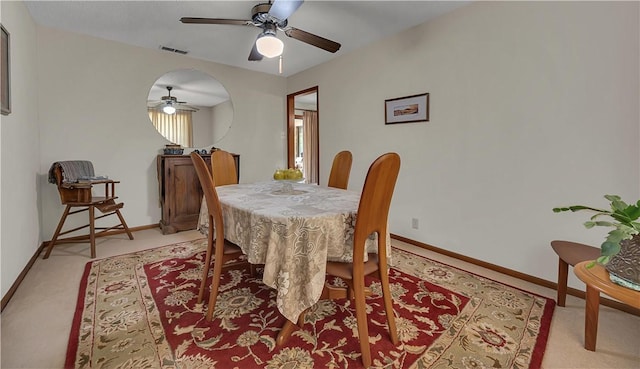 dining room featuring ceiling fan and light carpet