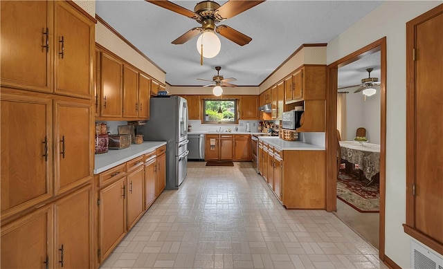 kitchen with crown molding, ceiling fan, and appliances with stainless steel finishes