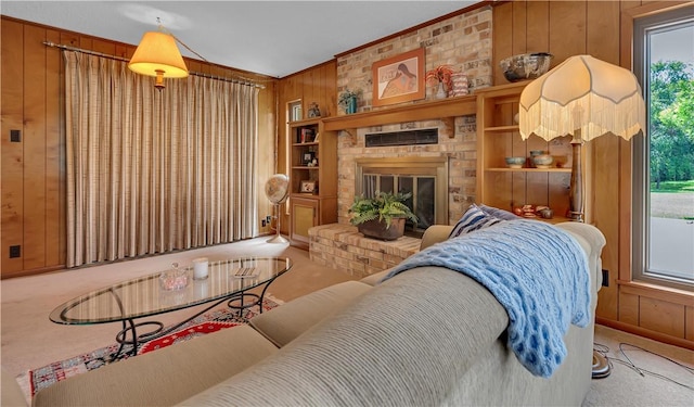 living room featuring crown molding, carpet floors, a fireplace, and wooden walls