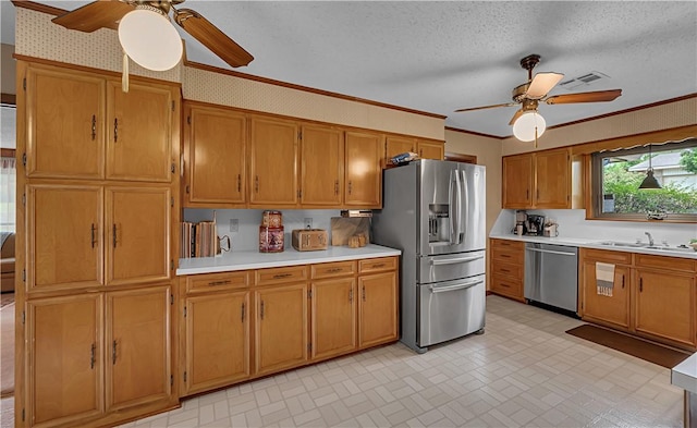 kitchen featuring appliances with stainless steel finishes, ornamental molding, and sink