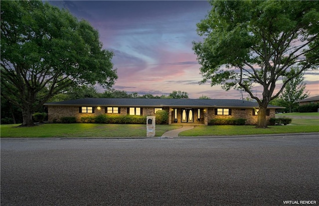 single story home featuring a lawn