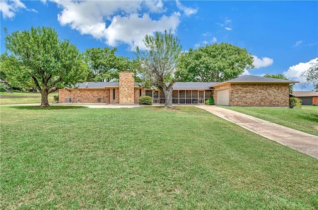 ranch-style house with a garage and a front lawn