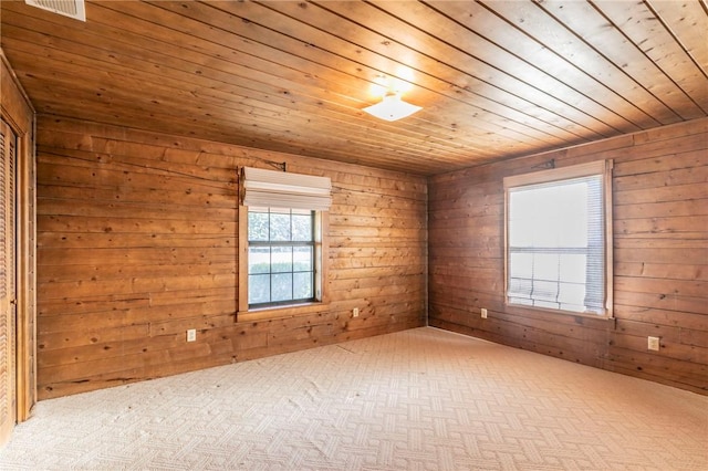 spare room with wood ceiling and wood walls