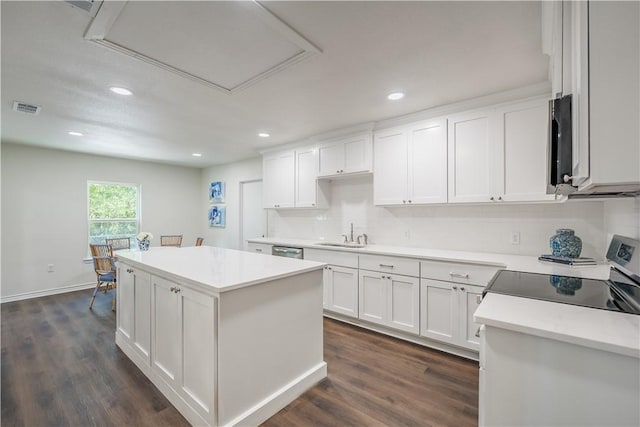 kitchen with dark hardwood / wood-style flooring, black range oven, sink, white cabinets, and a center island