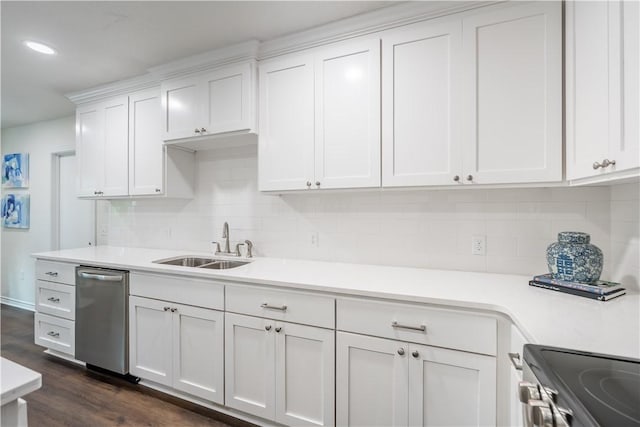 kitchen featuring sink, stainless steel appliances, dark hardwood / wood-style flooring, decorative backsplash, and white cabinets