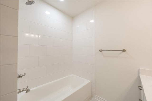 bathroom featuring vanity and tiled shower / bath