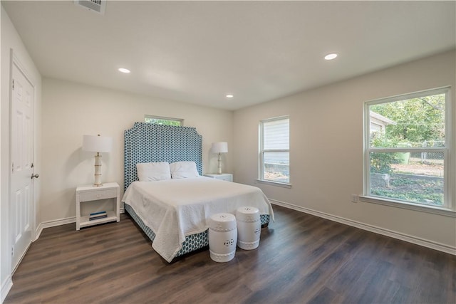 bedroom with dark hardwood / wood-style flooring