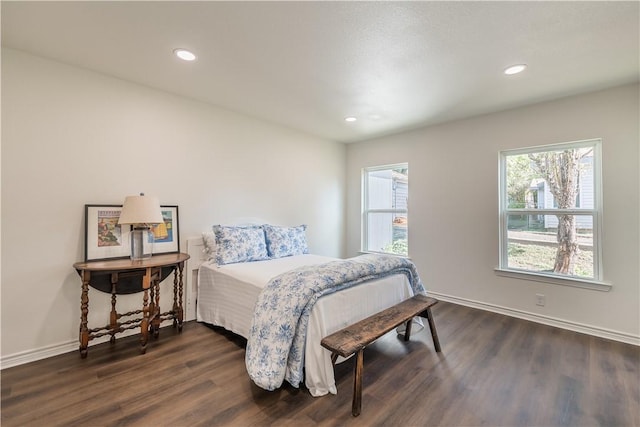 bedroom with dark hardwood / wood-style floors