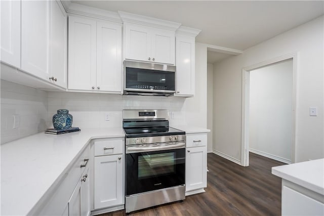 kitchen featuring white cabinets, backsplash, stainless steel appliances, and dark hardwood / wood-style floors