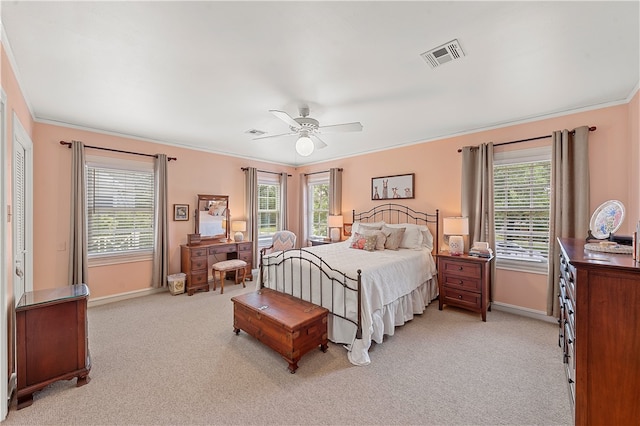 carpeted bedroom with ceiling fan, crown molding, and multiple windows