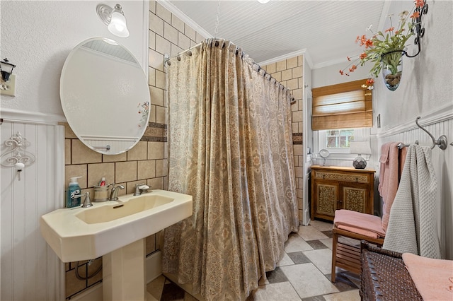 bathroom featuring tile walls and ornamental molding