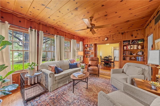 living room featuring plenty of natural light, light hardwood / wood-style floors, built in features, and wooden ceiling