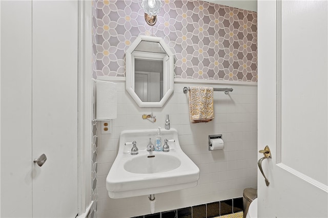 bathroom with tile walls and sink