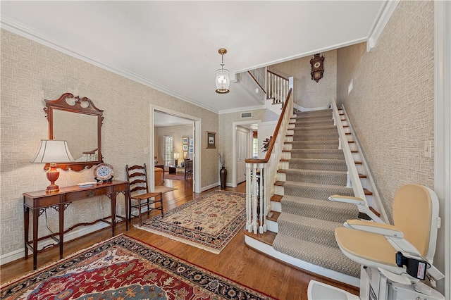 foyer with hardwood / wood-style floors and ornamental molding