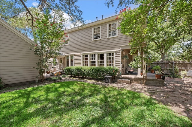 rear view of property featuring a yard and a patio area