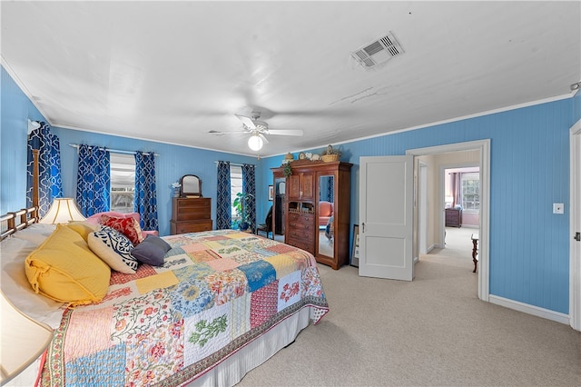 bedroom featuring ceiling fan, crown molding, and light carpet