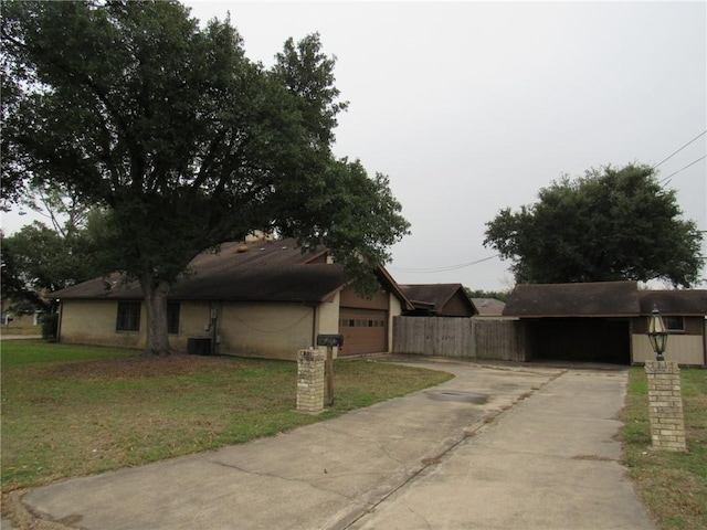 view of side of home featuring a yard and a garage