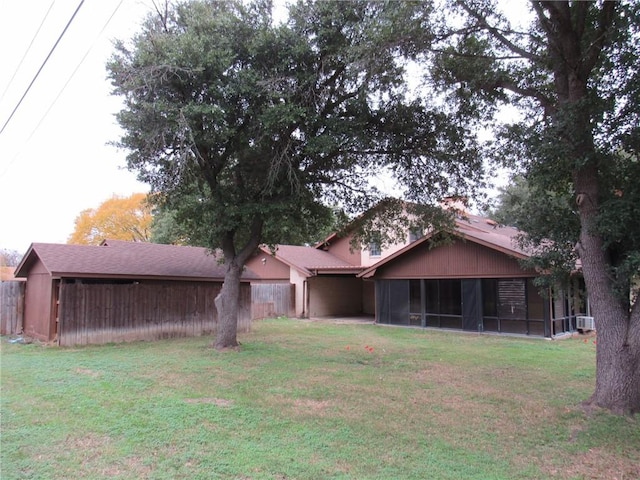 view of front facade with a sunroom and a front lawn