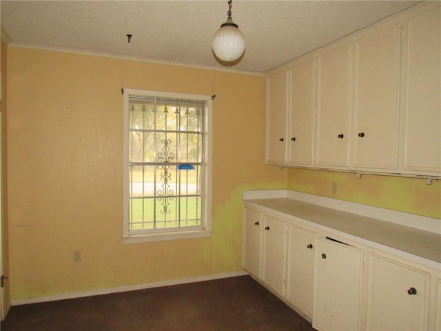 kitchen featuring white cabinets, plenty of natural light, and hanging light fixtures