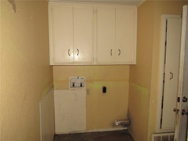 washroom with cabinets, hookup for a washing machine, and hookup for an electric dryer