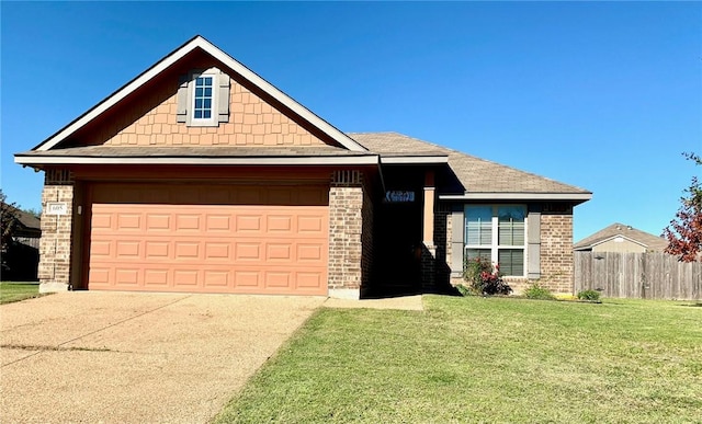 view of front of house featuring a garage and a front lawn