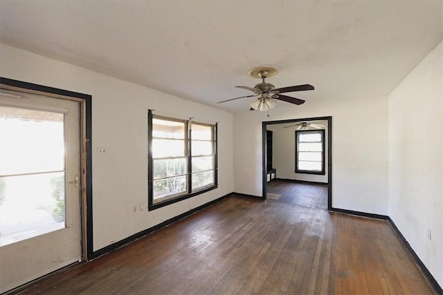 unfurnished room with dark hardwood / wood-style floors, a wealth of natural light, and ceiling fan