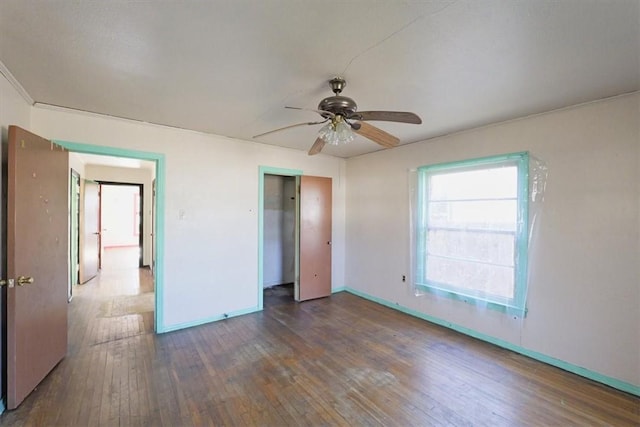 unfurnished bedroom featuring dark hardwood / wood-style floors and ceiling fan