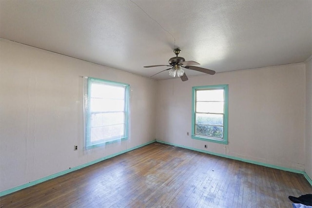 unfurnished room featuring hardwood / wood-style flooring, ceiling fan, and a textured ceiling