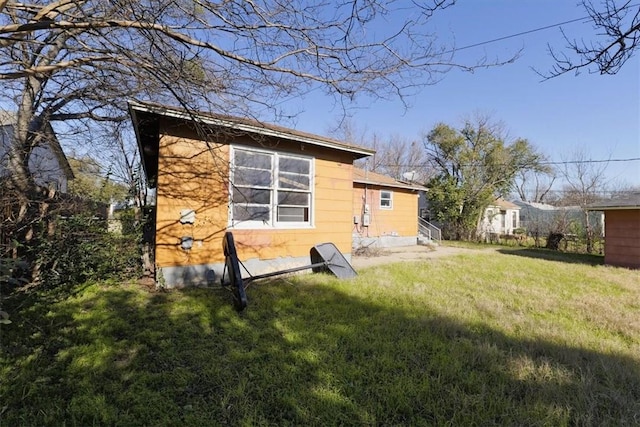 rear view of property with a lawn