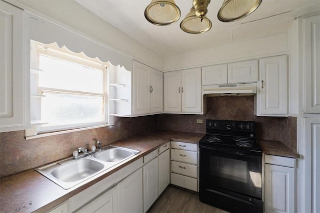 kitchen with tasteful backsplash, black electric range oven, sink, white cabinets, and dark wood-type flooring