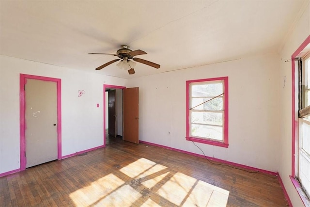 empty room with ceiling fan and dark hardwood / wood-style flooring