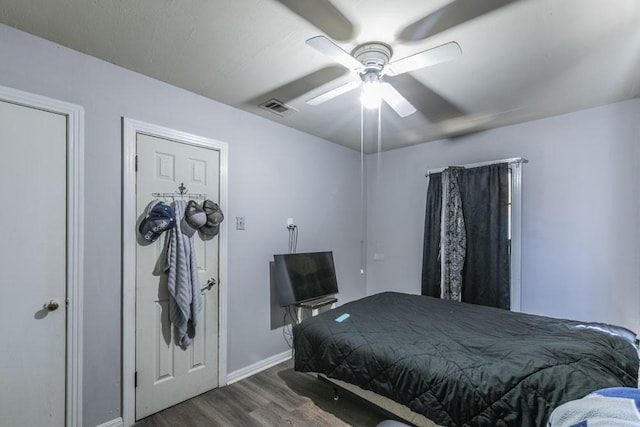 bedroom featuring dark hardwood / wood-style floors and ceiling fan