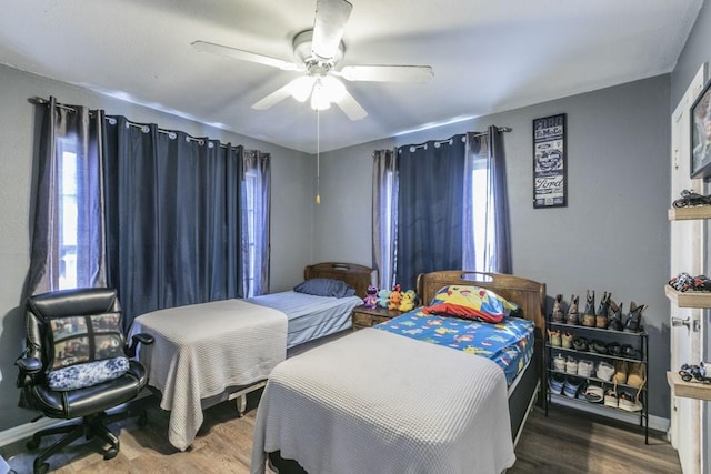 bedroom with hardwood / wood-style flooring and ceiling fan