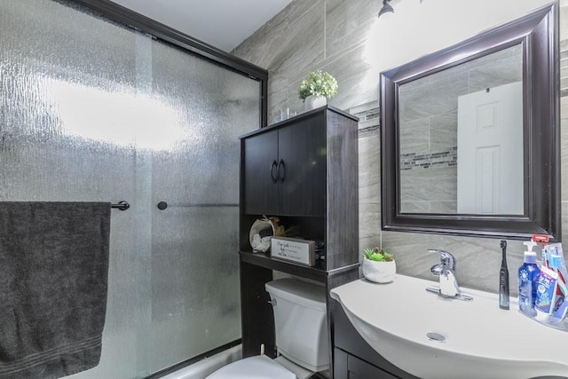 full bathroom with vanity, toilet, decorative backsplash, and combined bath / shower with glass door