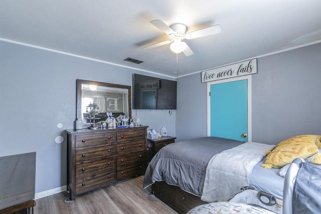 bedroom with hardwood / wood-style floors and ceiling fan