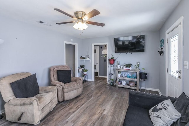 living room featuring ceiling fan and dark hardwood / wood-style flooring