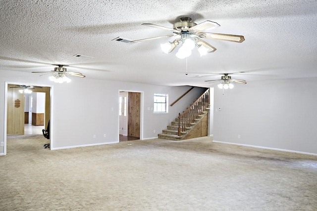 spare room featuring a textured ceiling and carpet floors