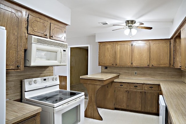 kitchen with decorative backsplash, ceiling fan, and white appliances