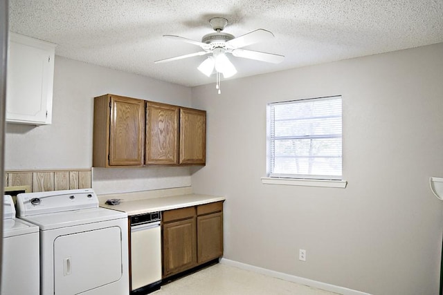 laundry room with ceiling fan, washing machine and dryer, and a textured ceiling