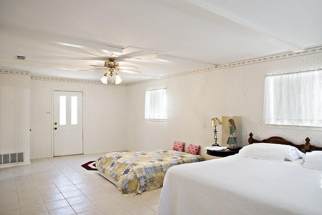 tiled bedroom with multiple windows, ceiling fan, and beamed ceiling