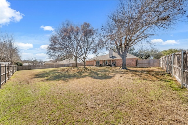 view of yard with a fenced backyard