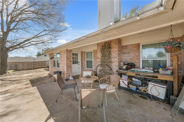 view of patio / terrace featuring fence