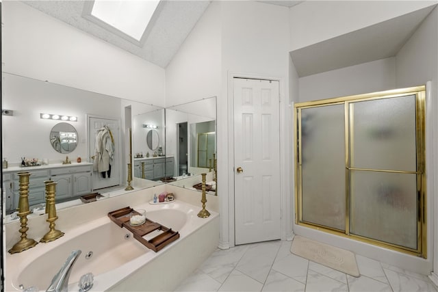 full bath featuring a skylight, marble finish floor, a closet, a shower stall, and a whirlpool tub