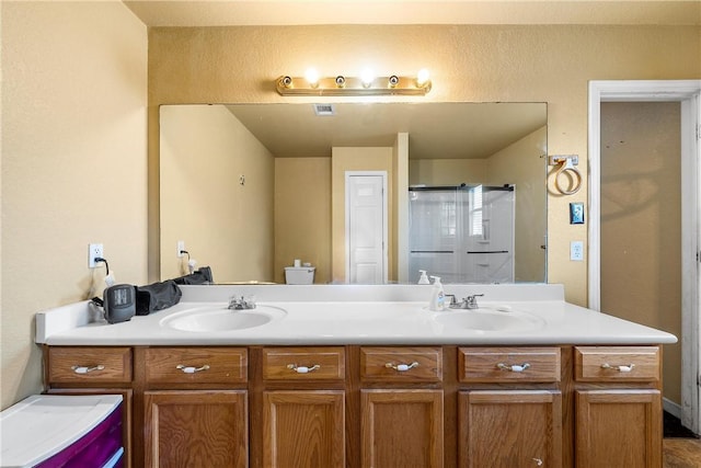 bathroom with walk in shower and vanity