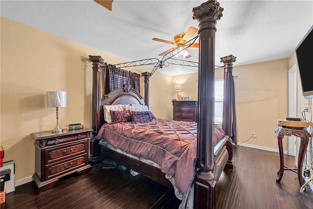 bedroom with a textured ceiling, ceiling fan, and dark hardwood / wood-style floors