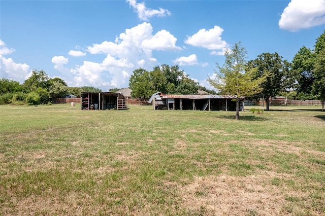 view of yard with a rural view and an outdoor structure