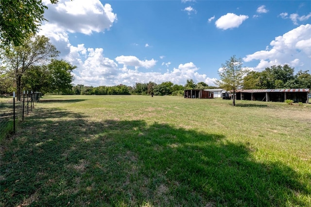 view of yard featuring an outbuilding and a rural view